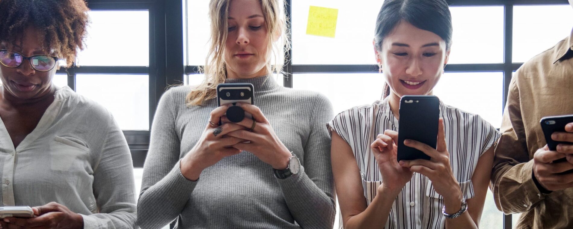 Group of diverse people using smartphones