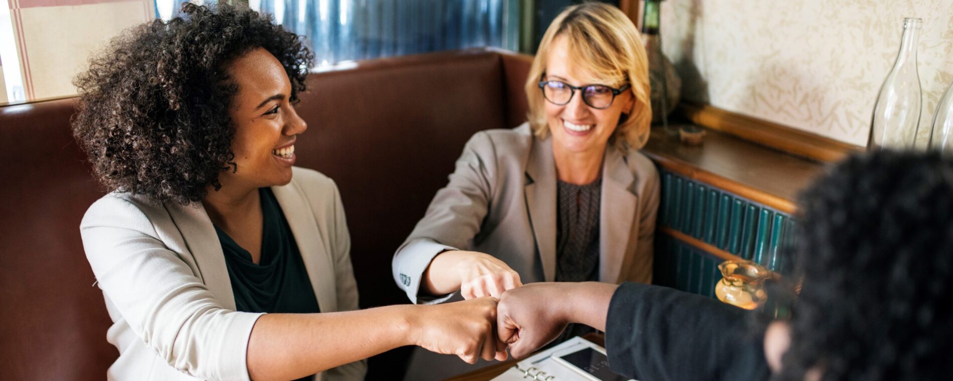 Businesswomen in a fist bump