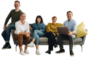 a group of smiling people sitting on a long sofa
